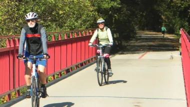 People riding bike son paved greenway in Indianapolis, Indiana.